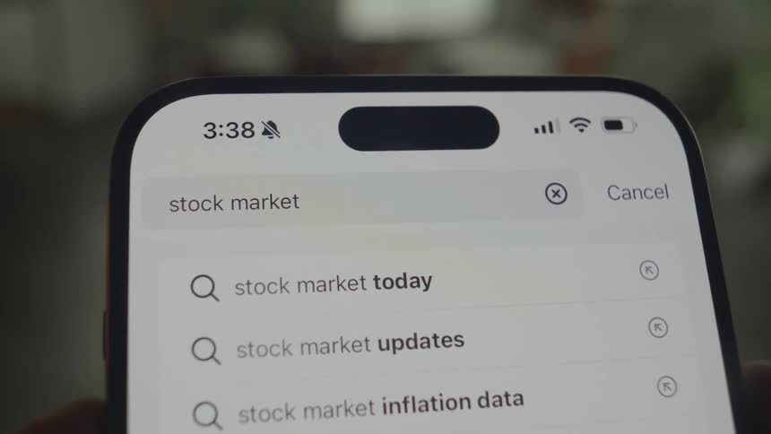 Closeup of an iphone screen and text being typed into a search bar