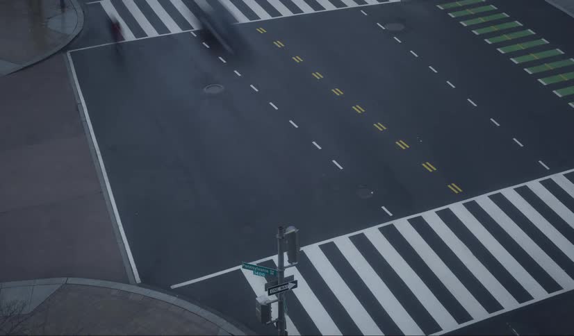 Pedestrians and vehicles travel through the intersection