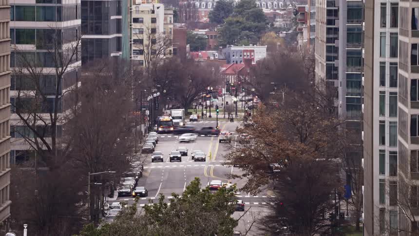 People and traffic move through a city