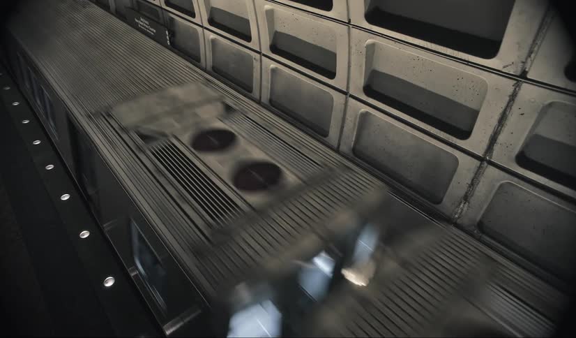 Train moving through an underground subway station