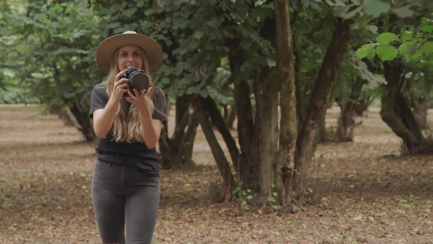 A woman takes a photograph with her camera