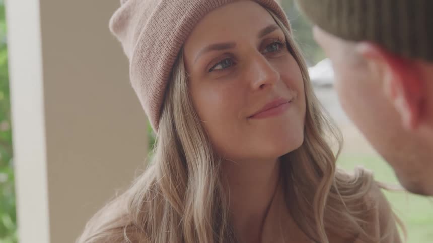 Woman raising her head and looking at a man in a romantic way
