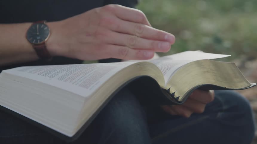 A person turns the pages of a book