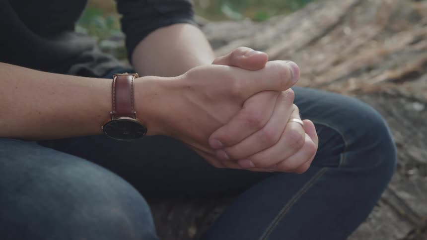 Close up of a pair of hands clasped together