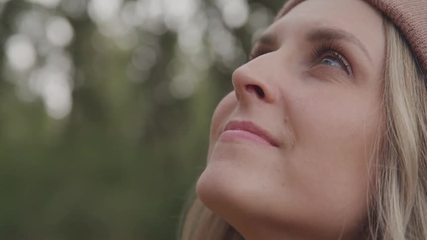 Woman with happy facial expression looking up