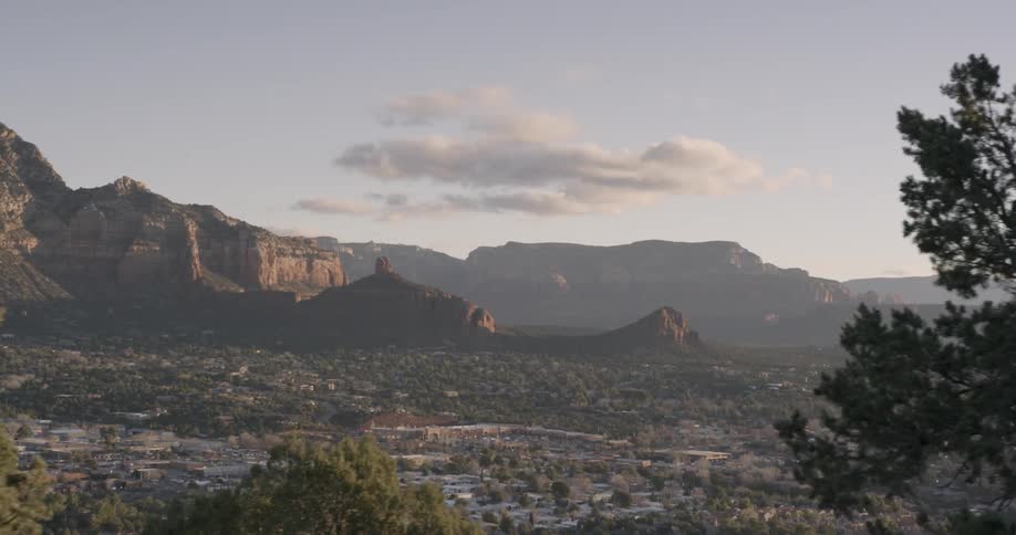 A view of a city below a high mountain range