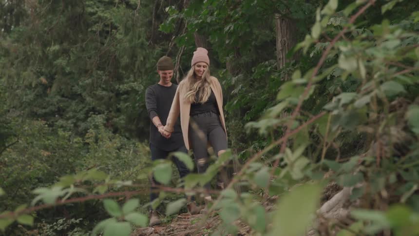A couple take a hike in the woods