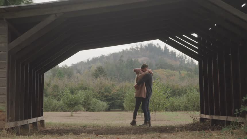 A couple hug in a park