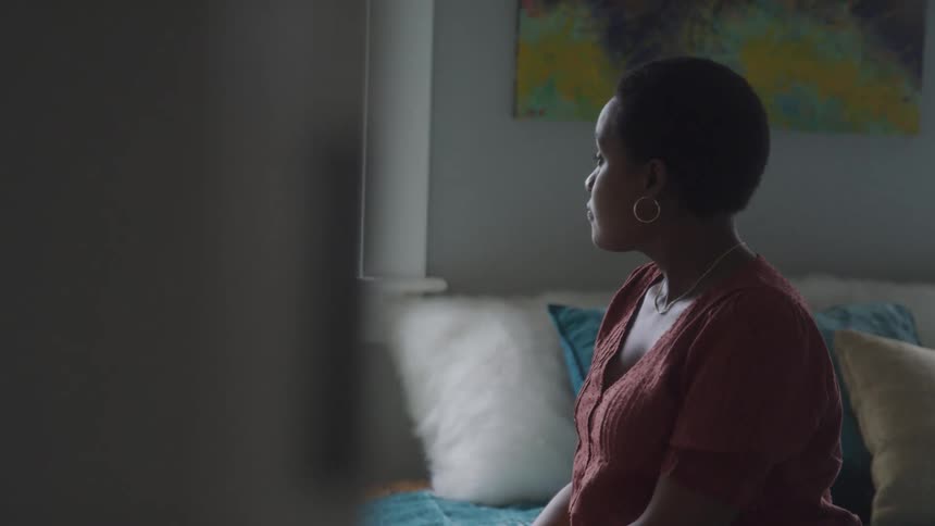 A woman looks out the window