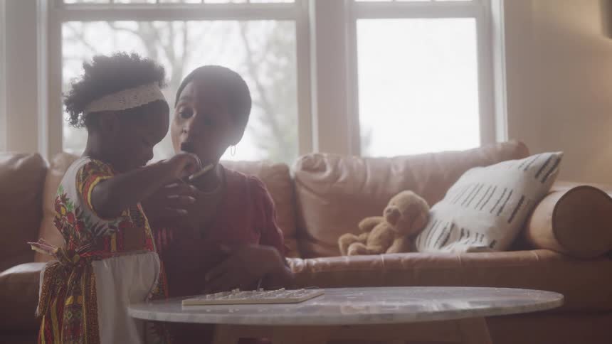A woman is playing a game with her daughter