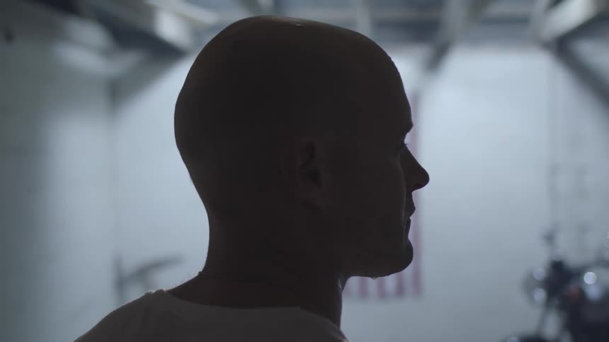 A man is standing in the dark