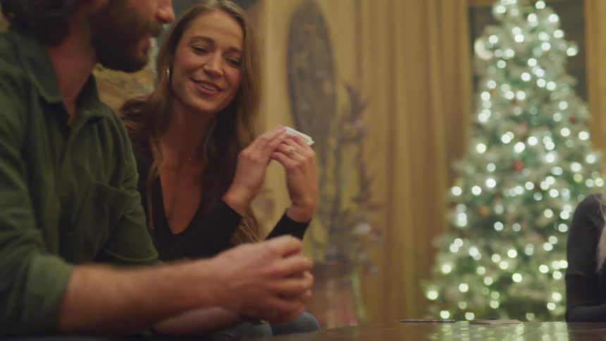 People sitting at a table playing cards
