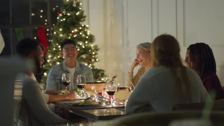 Group of friends sitting at a table talking and laughing