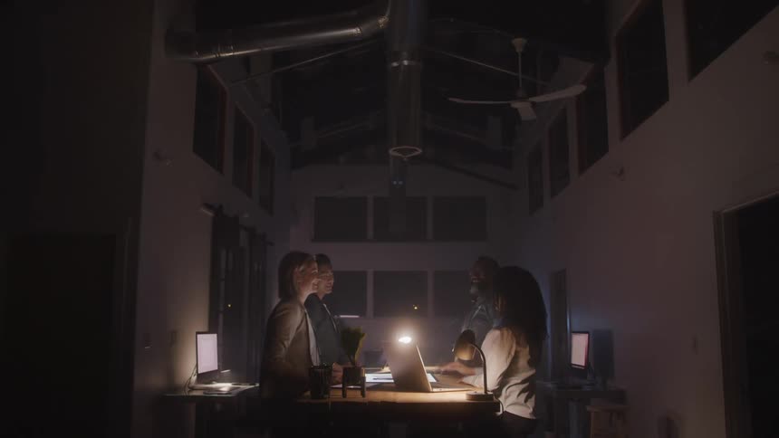 Four people are highfiving each other after the successful completion of a team project