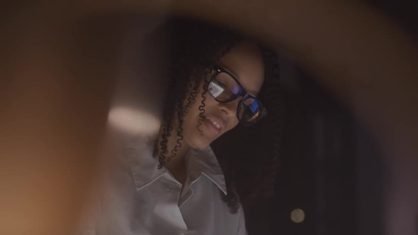Woman with glasses concentrating in an indoor environment