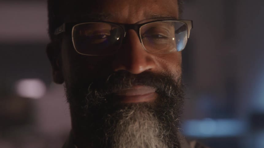 Portrait of a smiling man with a beard and glasses