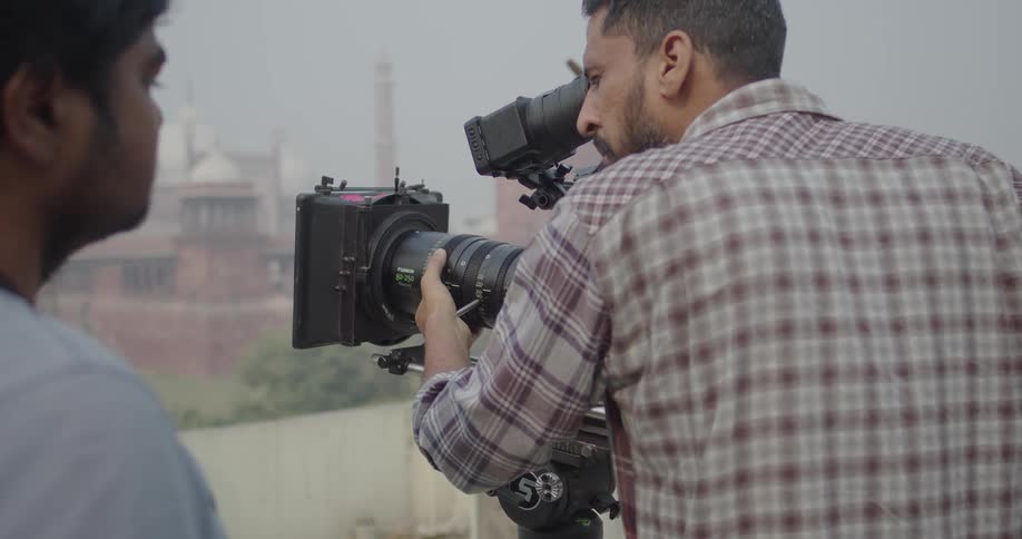 Filmmaker getting the perfect shot while filming outdoors