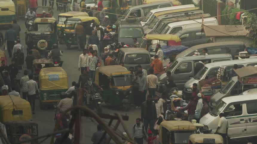 Busy openair shopping street with mini vans and pedestrians