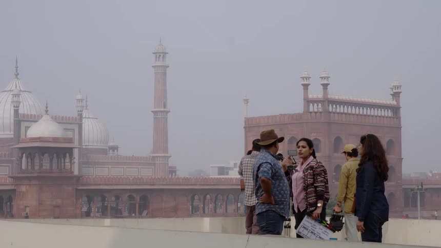 A group of tourists is near a temple