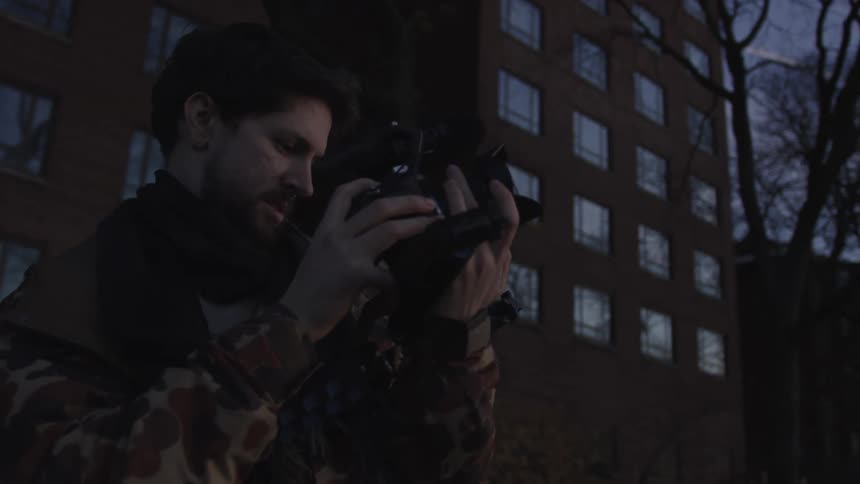 A man is photographing at sunset