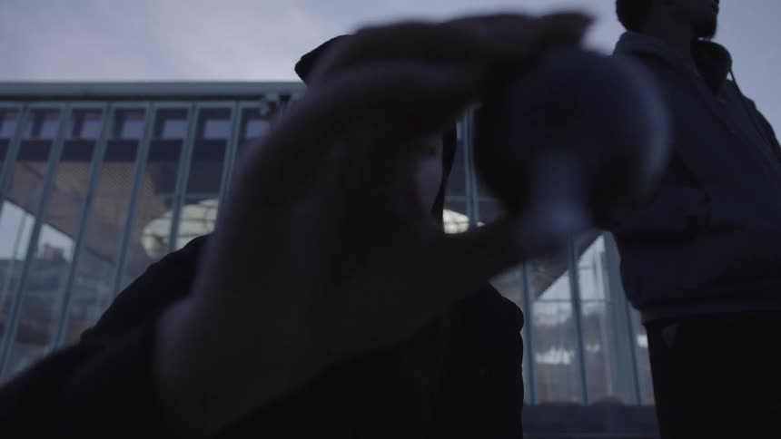 Woman holding an object against a camera