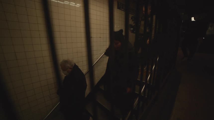 People climb down the stairs from the train station