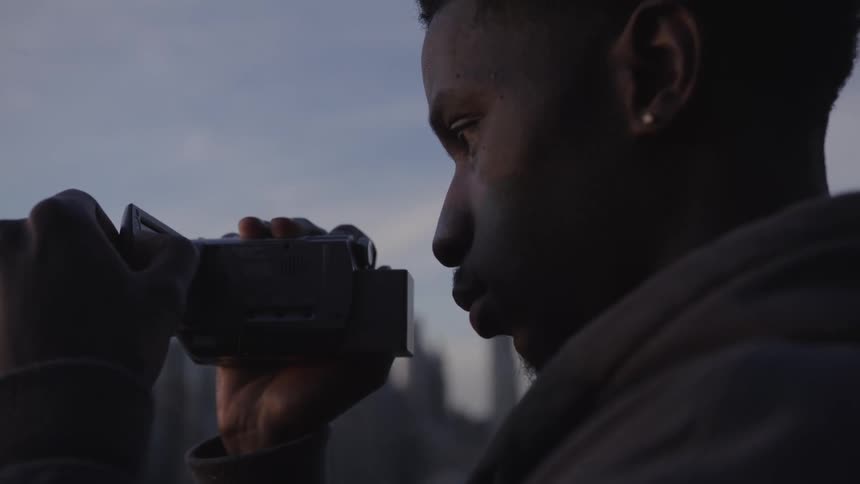 A clip of a person recording video with a camera