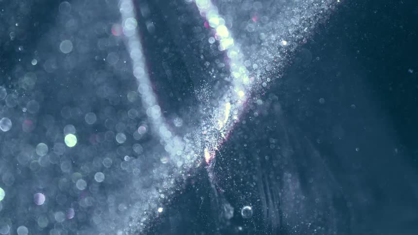 The light is moving down the object and making the dust particles sparkle