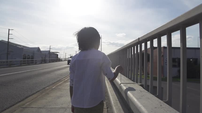 A child walks on a city sidewalk