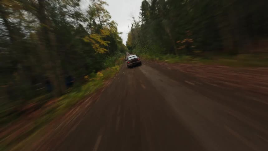 A car races on the dirt road