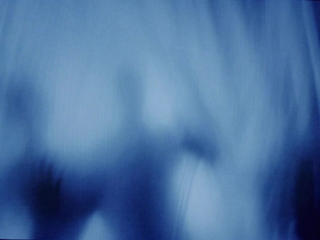 Abstract silhouette of a hand touching a translucent fabric