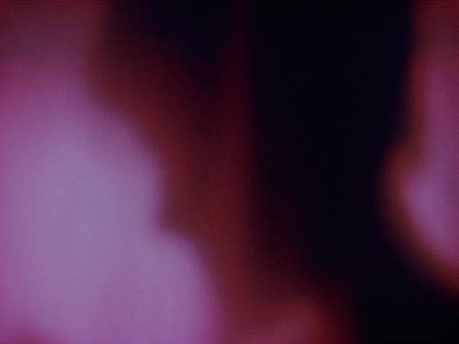 Shadow of an abstract body behind a red curtain in a lowlight environment