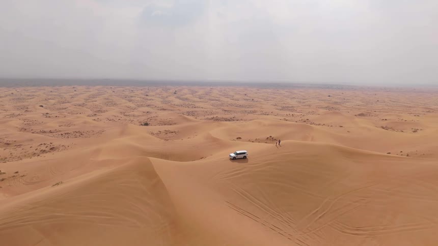 A white car in the middle of the desert