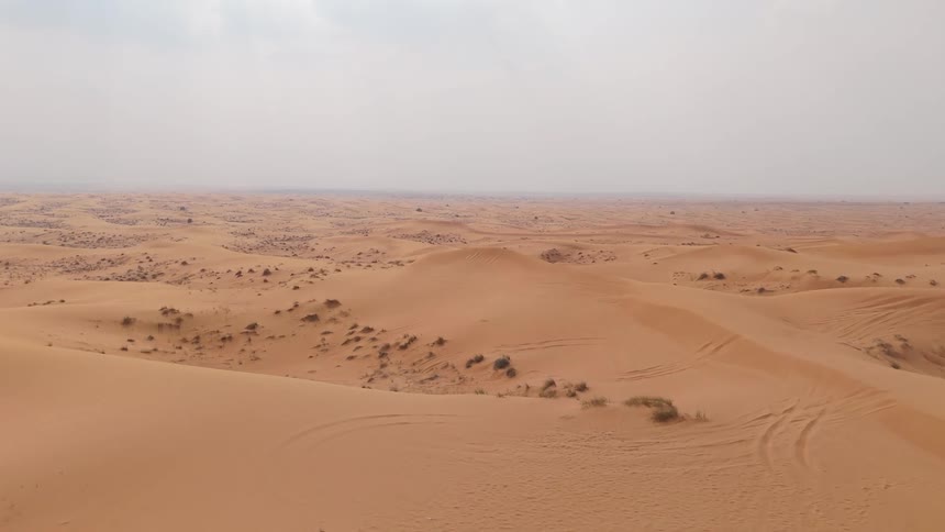 Aerial view of a vast desert on a cloudy day