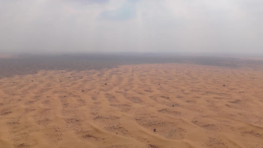 Thick fog is covering the desert sand and horizon