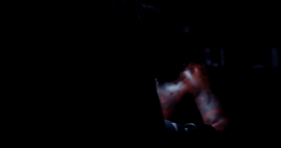 A boxer is punching the heavy bag