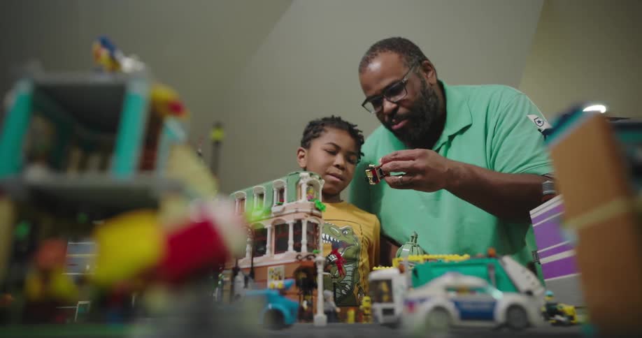 Father and son in a room interacting with lego toys