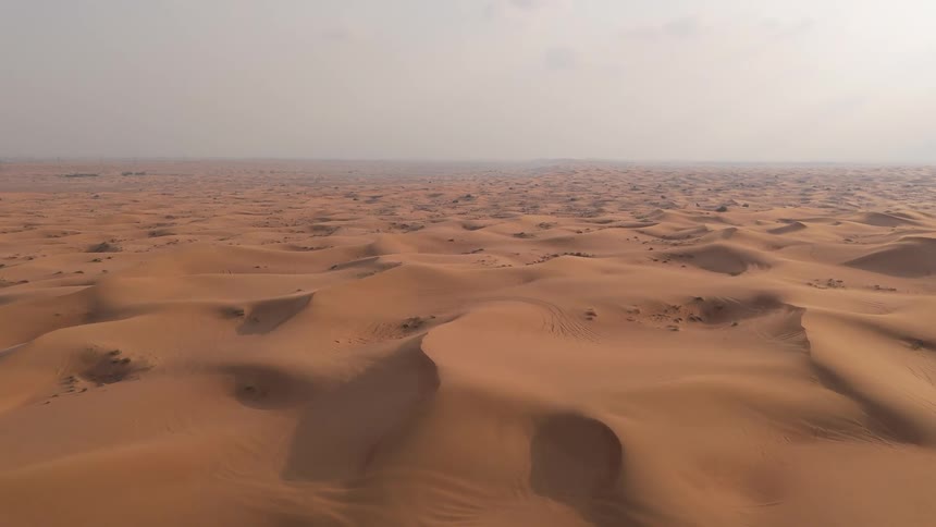 Aerial view of a vast desert with dunes