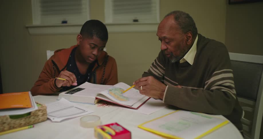 A grandfather explaining a school lesson to his grandson