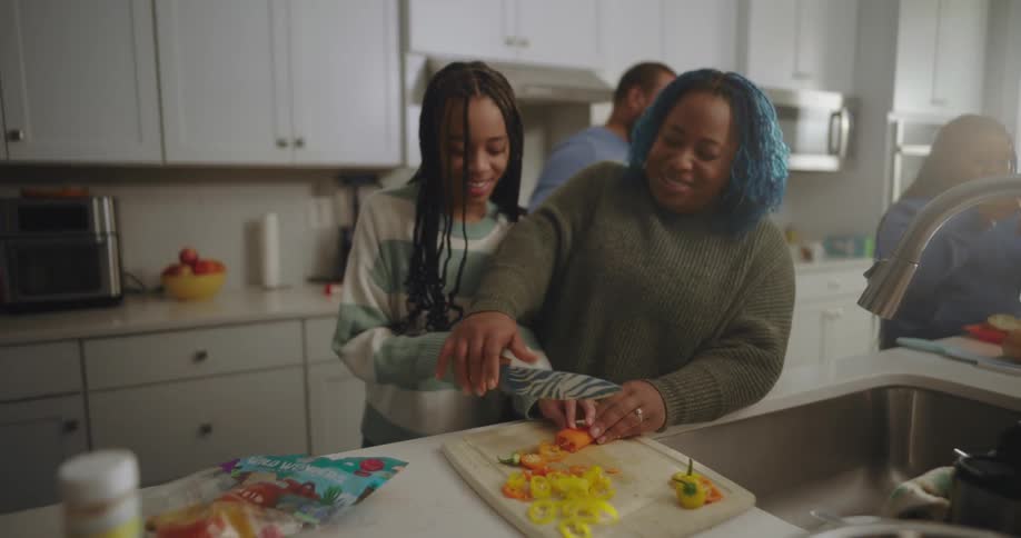 A family is cooking in the kitchen