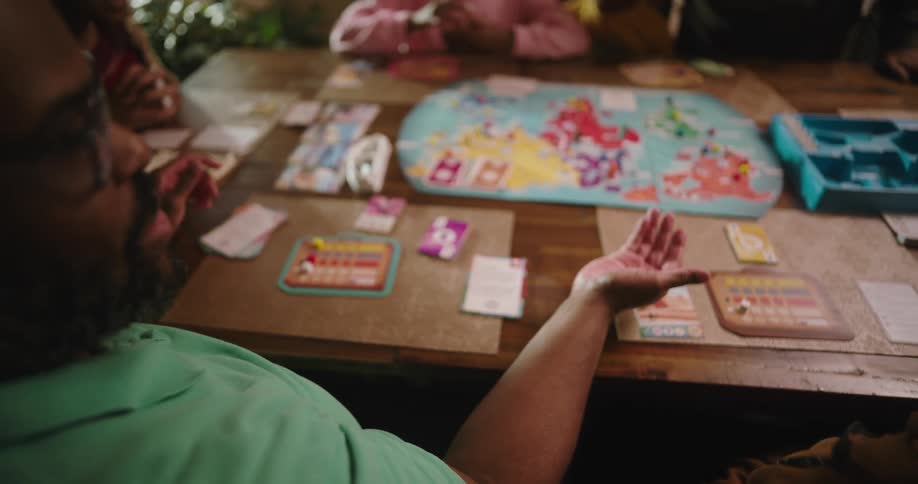 Family sitting at table playing board game