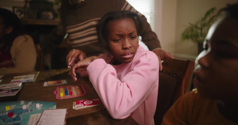 A girl makes a funny face at her brother