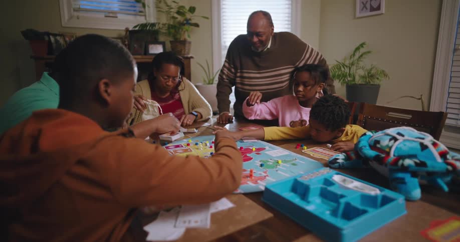A family gathered around a table playing a large board game