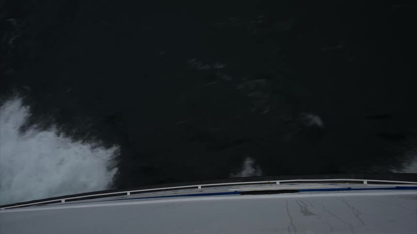The hull of a boat moves through water quickly enough to cause waves