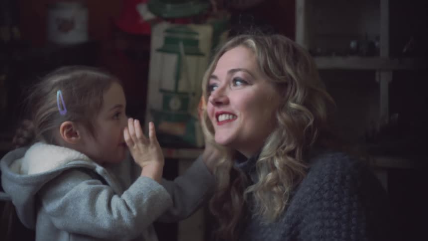 A girl shows her mom a sea shell