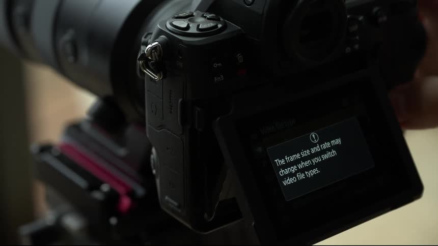 A person is scrolling through a menu on a camera screen