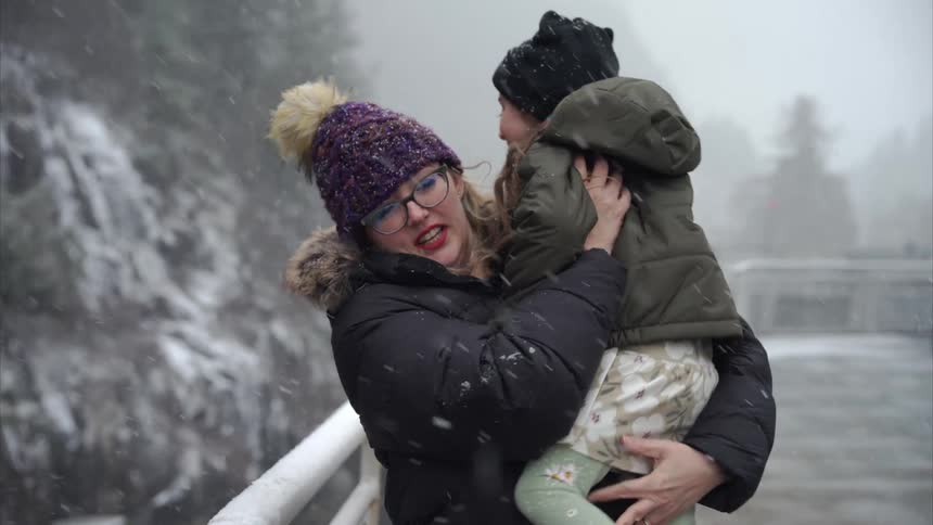 A footage of a mother carrying her daughter