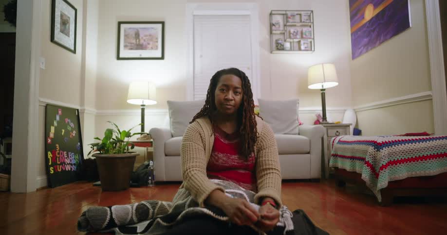 A woman sitting on the floor of a living room