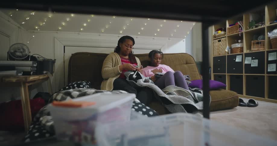 Mother and daughter sitting on the couch