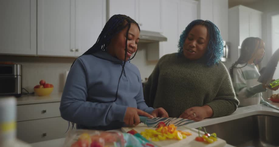 A family are cooking together in the kitchen